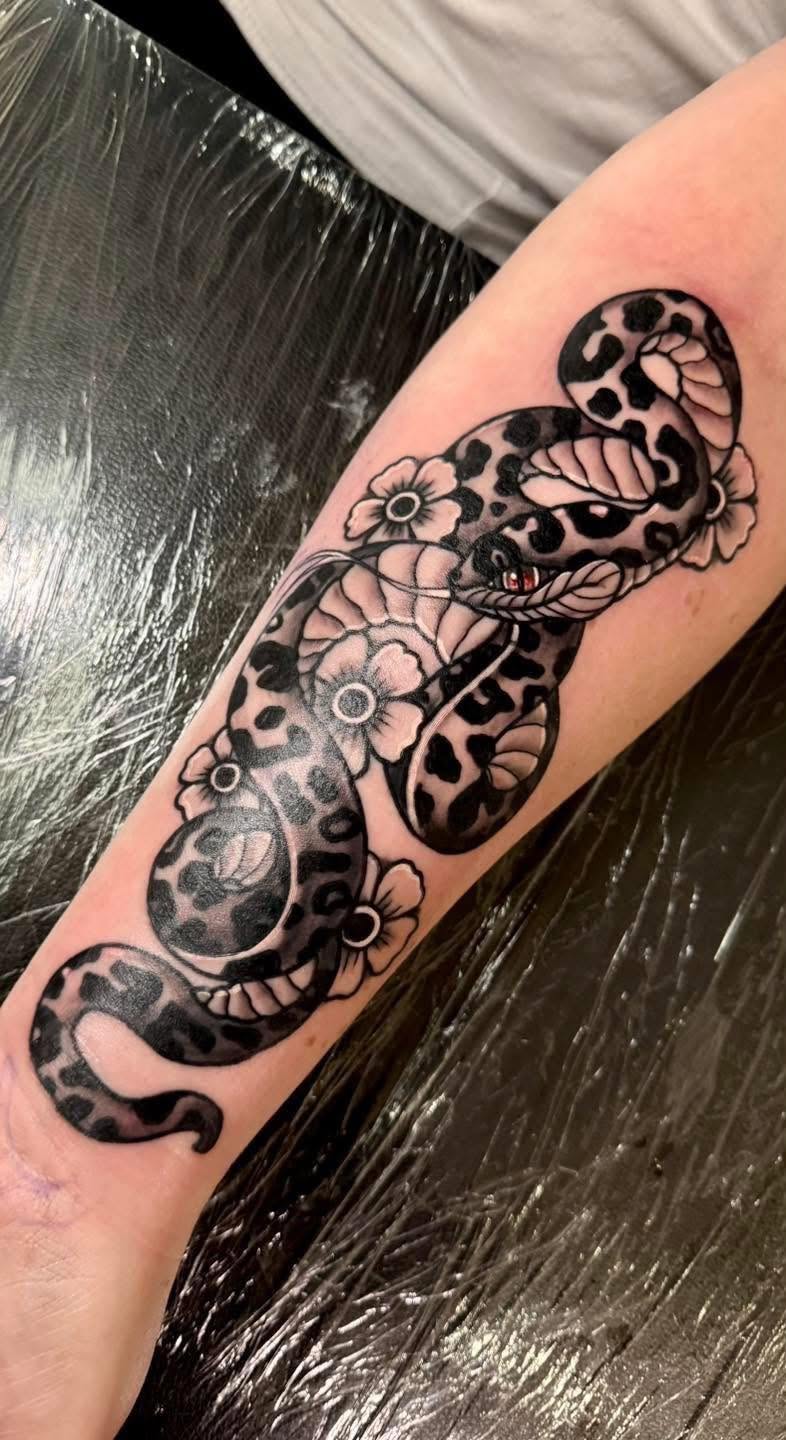 Neo-traditional leopard-print snake and flowers forearm tattoo by Love and Chaos Tattoo Gallery, Mudgee NSW
