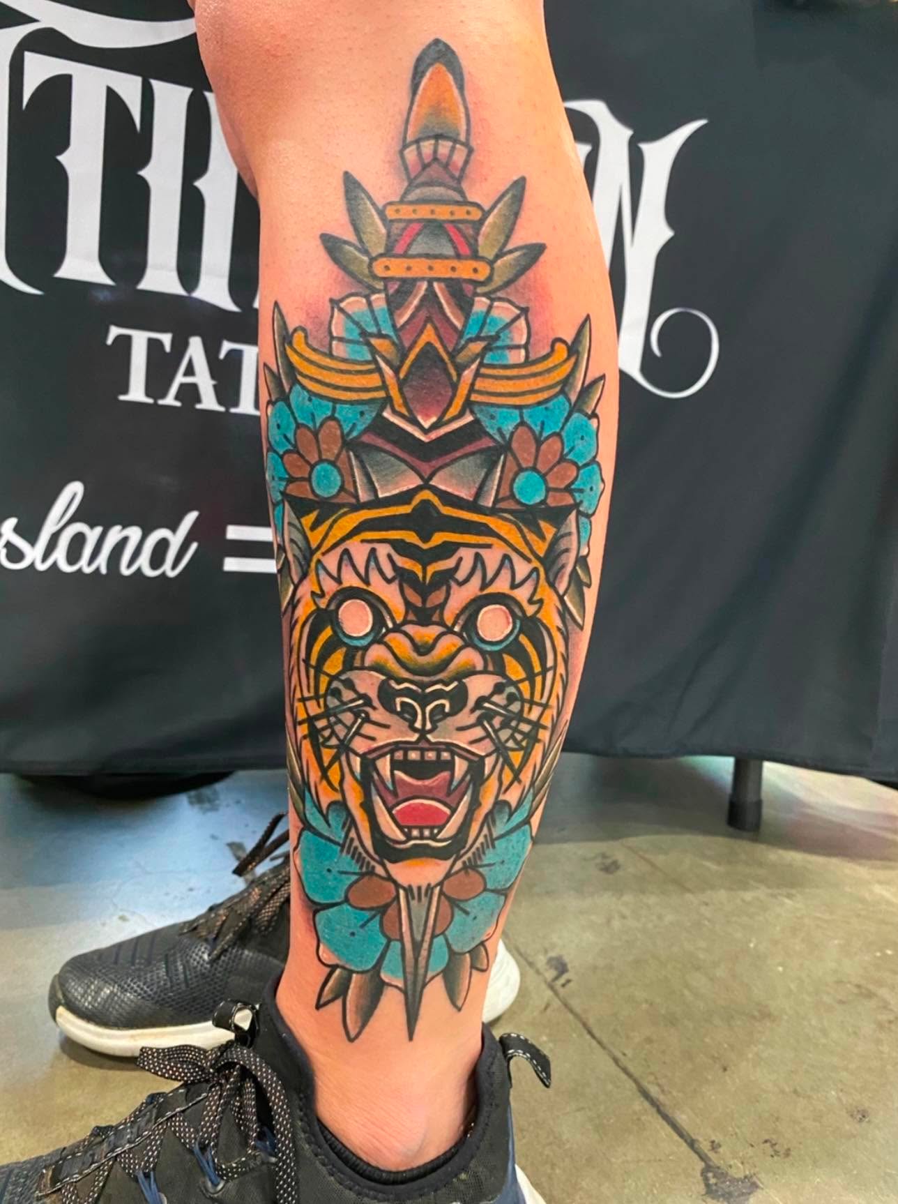 Traditional colour tiger and dagger calf tattoo by Love and Chaos Tattoo Gallery, Mudgee NSW