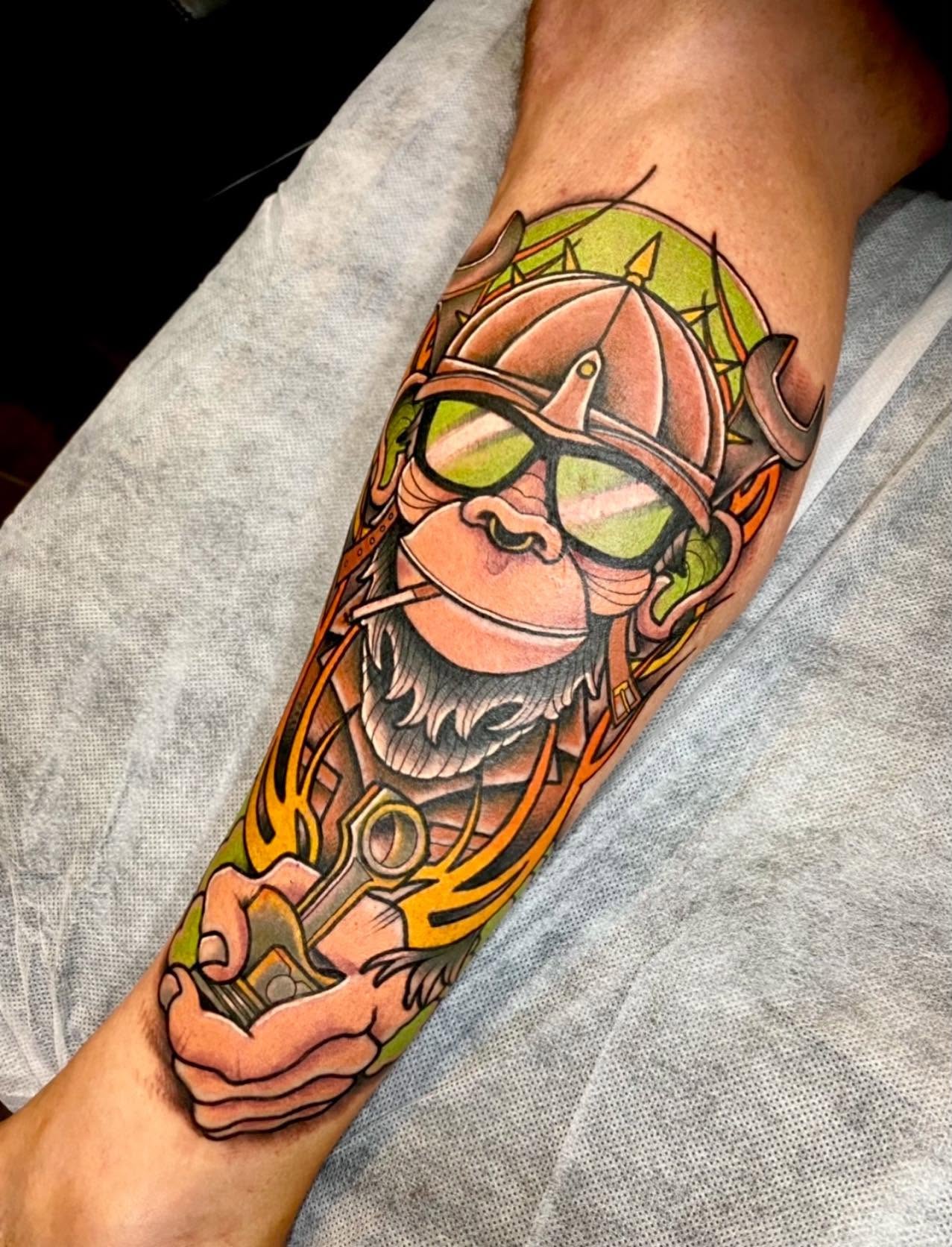 Neo-traditional colour biker chimpanzee with helmet, goggles and piston leg tattoo by Love and Chaos Tattoo Gallery, Mudgee NSW