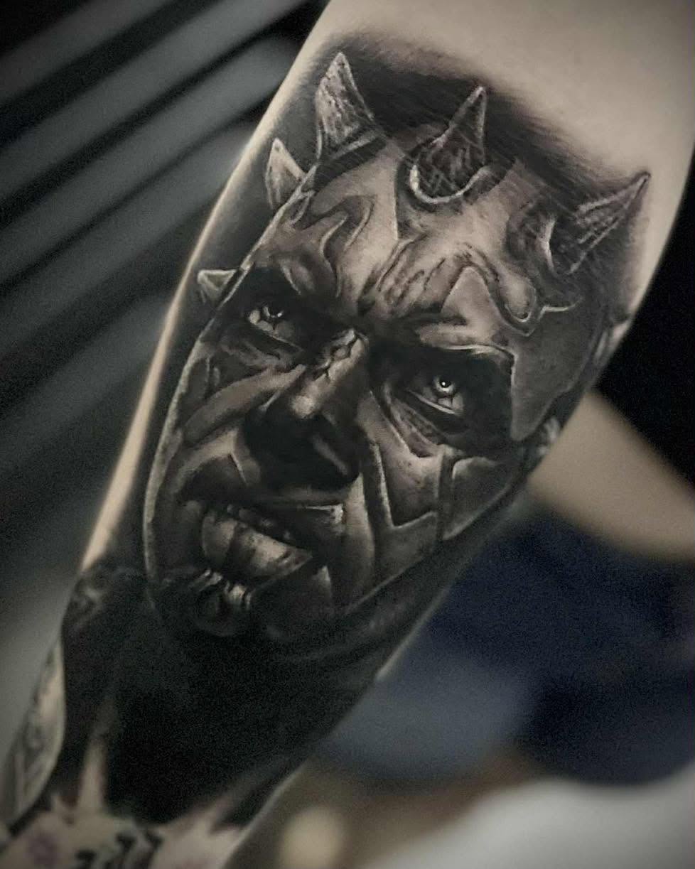 Black and grey realism demon mask forearm tattoo by Love and Chaos Tattoo Gallery, Mudgee NSW