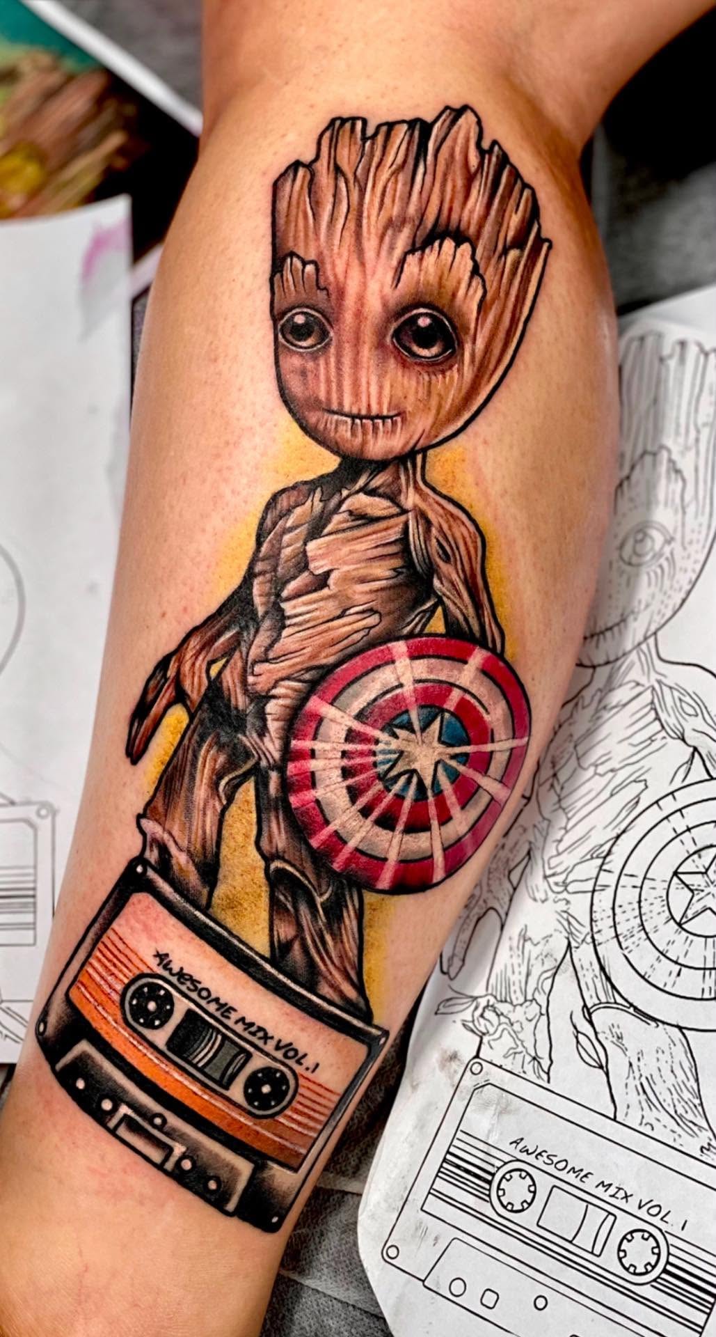 Colour illustrative Baby Groot and cassette tape leg tattoo by Love and Chaos Tattoo Gallery, Mudgee NSW