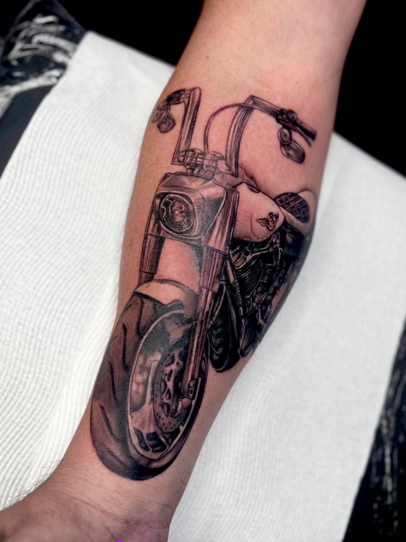 Black and grey realism Harley-Davidson motorcycle forearm tattoo by Love and Chaos Tattoo Gallery, Mudgee NSW