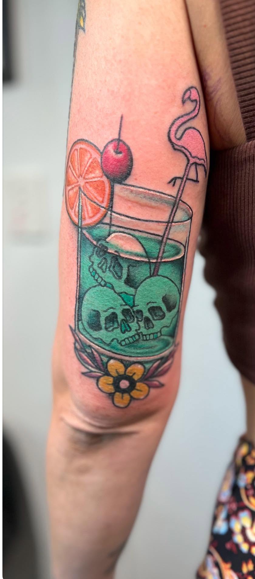 Traditional colour cocktail glass with skull and flamingo straw arm tattoo by Love and Chaos Tattoo Gallery, Mudgee NSW